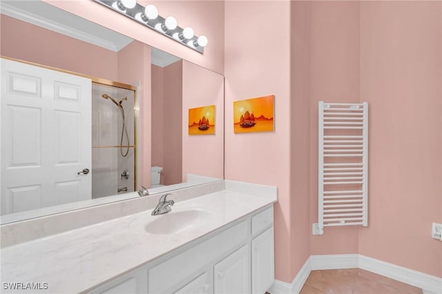 full bathroom featuring tiled shower / bath, radiator, vanity, toilet, and tile patterned floors