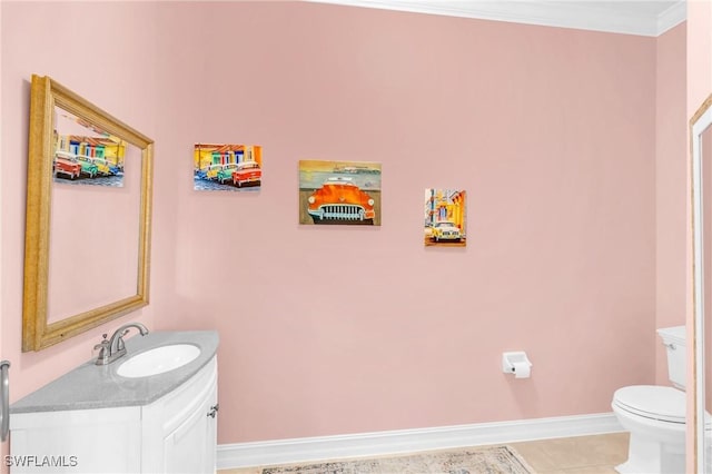 bathroom featuring ornamental molding, tile patterned floors, toilet, and vanity