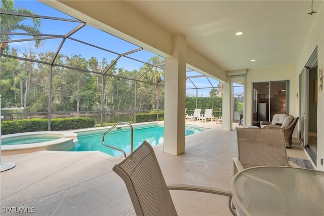12560 Wildcat Cove Cir, Estero, FL 33928 - view of swimming pool with a patio area, a pool with connected hot tub, outdoor dining area, a lanai, and view of scattered trees