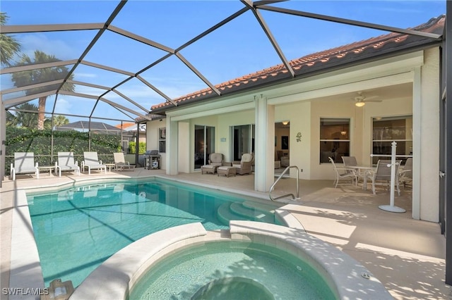 view of pool featuring a patio, an in ground hot tub, an outdoor hangout area, ceiling fan, and glass enclosure