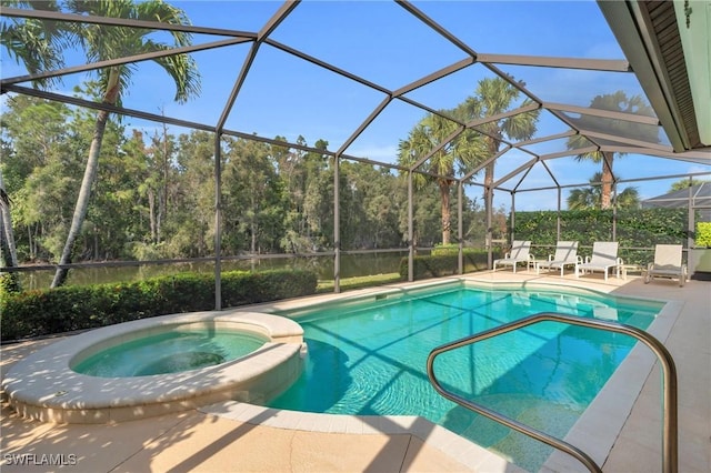 view of pool featuring a patio area, glass enclosure, and an in ground hot tub