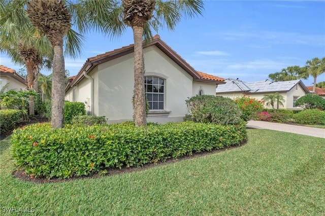 view of side of home featuring a lawn