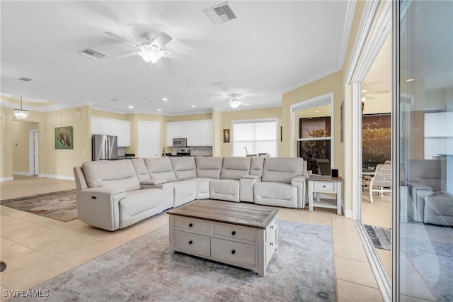 tiled living room featuring crown molding and ceiling fan