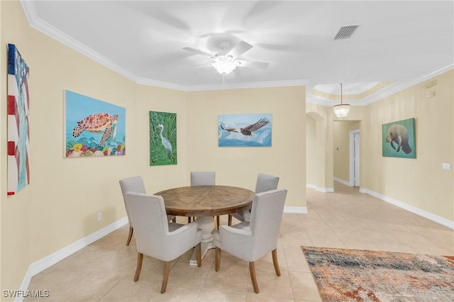 tiled dining space featuring crown molding and ceiling fan