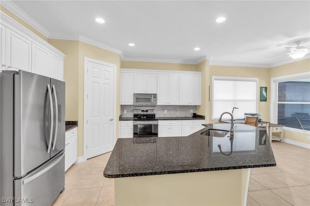 12560 Wildcat Cove Cir, Estero, FL 33928 - kitchen with stainless steel appliances, a sink, light tile patterned flooring, white cabinets, and a center island with sink