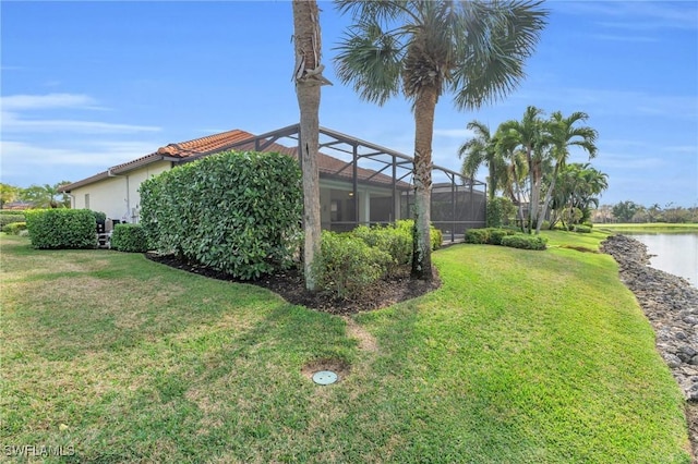 view of yard featuring a water view and a lanai