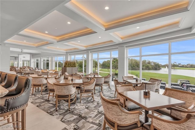 sunroom featuring a water view, beamed ceiling, coffered ceiling, and a wealth of natural light