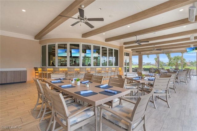 interior space featuring ceiling fan, beam ceiling, and light hardwood / wood-style floors