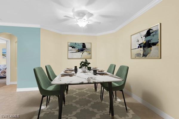 12560 Wildcat Cove Cir, Estero, FL 33928 - dining room featuring arched walkways, ornamental molding, baseboards, and ceiling fan