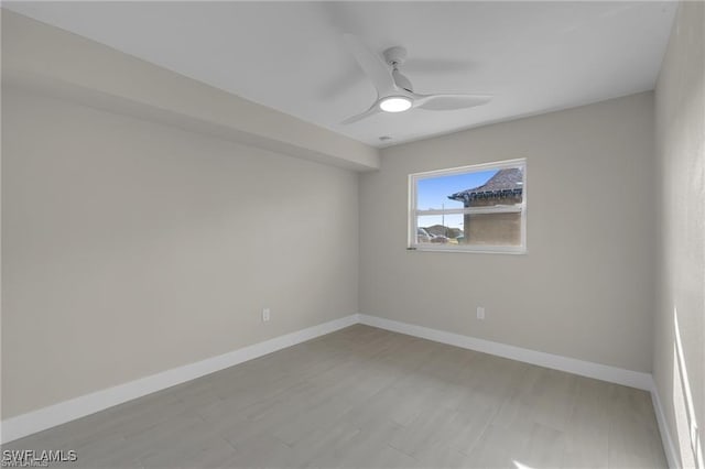 spare room featuring light hardwood / wood-style flooring and ceiling fan