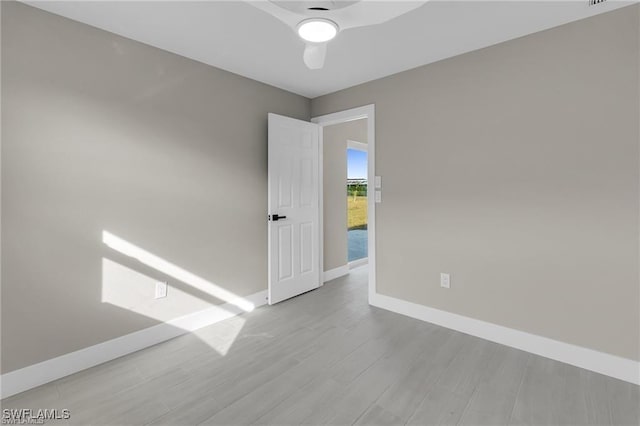 empty room with ceiling fan and light wood-type flooring