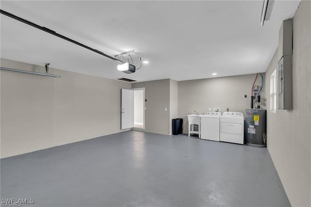 garage featuring a garage door opener, separate washer and dryer, and electric water heater