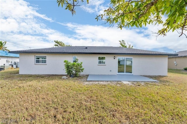 back of property featuring a patio area and a lawn