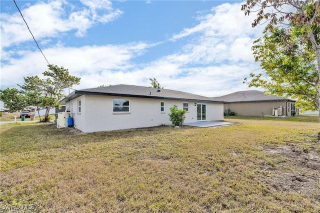 back of property featuring a patio and a lawn