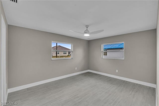 unfurnished room featuring light hardwood / wood-style floors and ceiling fan