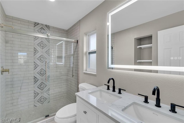 bathroom featuring vanity, toilet, and a shower with door