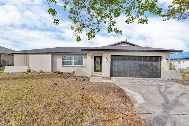 ranch-style house with a garage and a front lawn