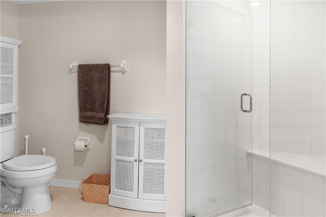 bathroom featuring toilet, an enclosed shower, and tile patterned flooring