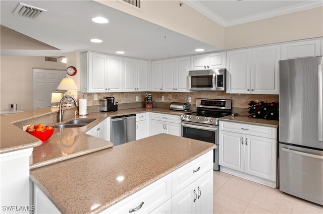 kitchen with white cabinetry, stainless steel appliances, and sink