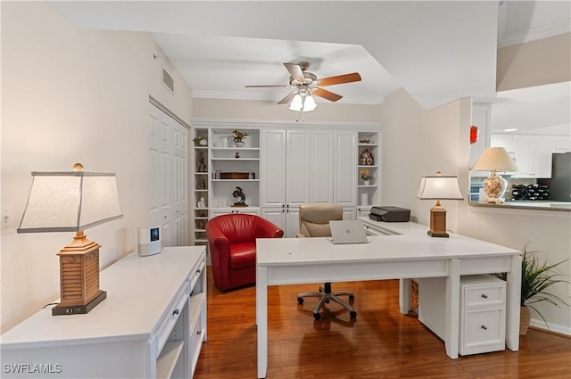 office space featuring crown molding, hardwood / wood-style flooring, and ceiling fan