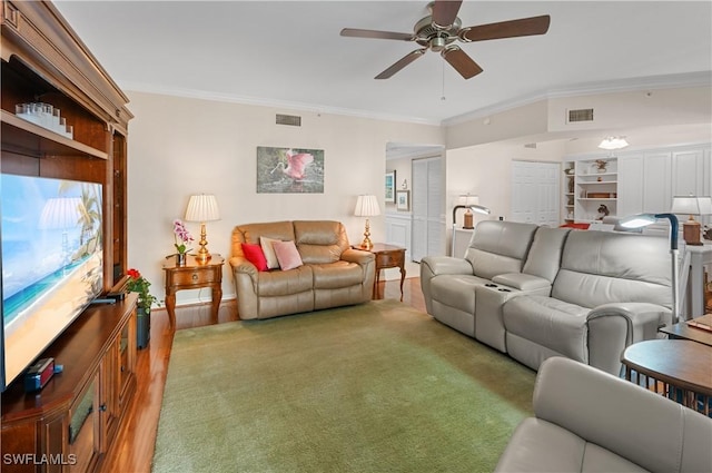 living room with ornamental molding and ceiling fan