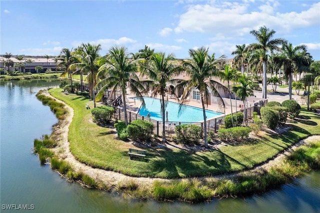 view of swimming pool with a water view and a yard