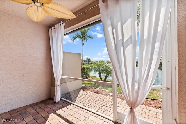 sunroom featuring a water view