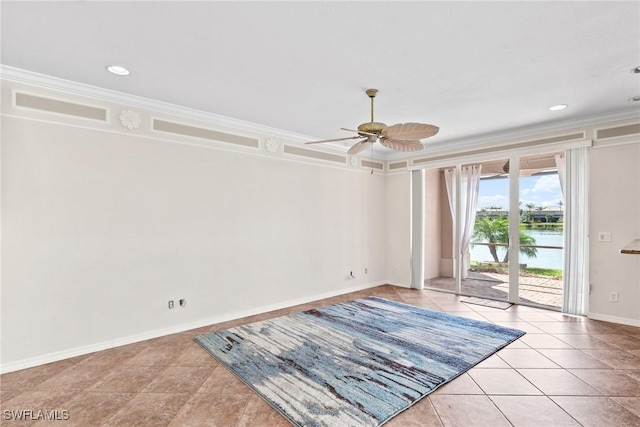 tiled empty room featuring crown molding, a water view, and ceiling fan