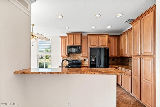 kitchen with light tile patterned flooring, tasteful backsplash, black appliances, light stone counters, and kitchen peninsula