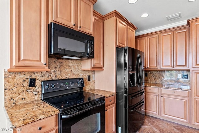 kitchen with light stone counters, decorative backsplash, and black appliances