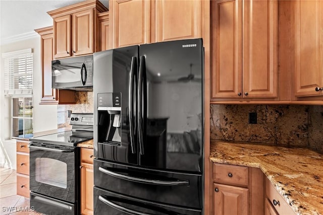 kitchen featuring light tile patterned floors, backsplash, light stone counters, ornamental molding, and black appliances