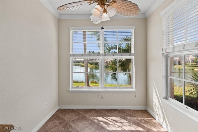 spare room featuring ornamental molding, a water view, a healthy amount of sunlight, and ceiling fan