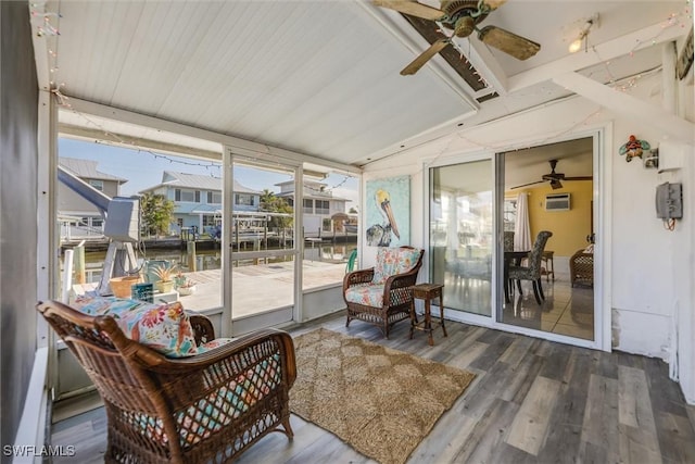 sunroom / solarium with a wall mounted AC and ceiling fan