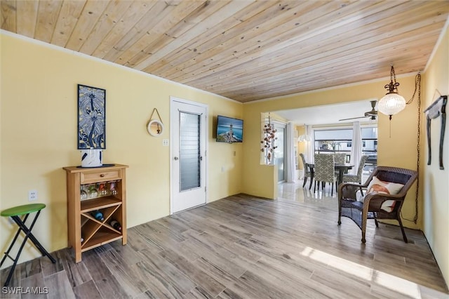 sitting room featuring crown molding, wooden ceiling, and light hardwood / wood-style flooring