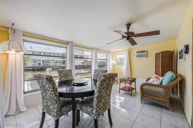 tiled dining space featuring ceiling fan and a wall mounted air conditioner