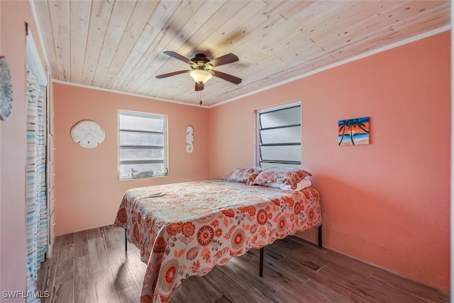 bedroom with ceiling fan, ornamental molding, hardwood / wood-style floors, and wooden ceiling