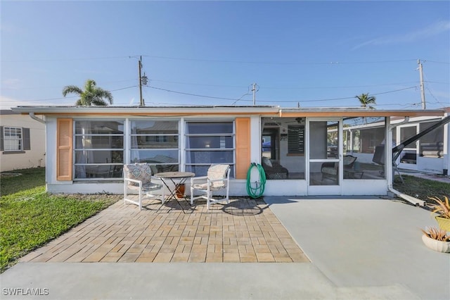 back of house featuring a patio area and a sunroom