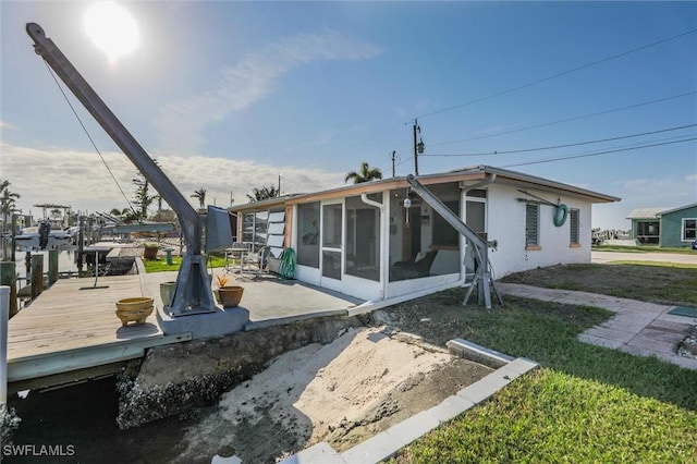 back of house featuring a sunroom and a patio area