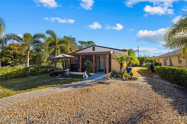 view of front of property featuring a sunroom and a front yard