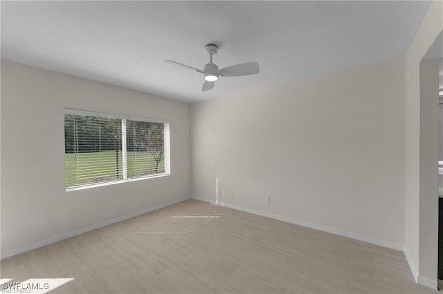 unfurnished room featuring light wood-type flooring and ceiling fan