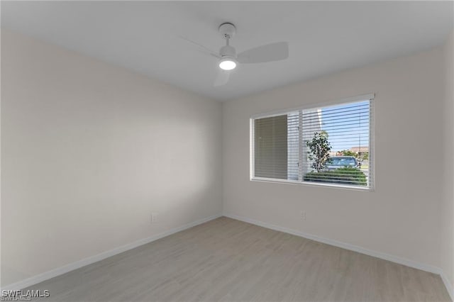 empty room featuring ceiling fan and light hardwood / wood-style flooring