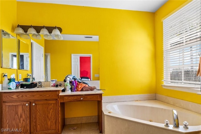 bathroom with vanity, a tub, and tile patterned floors