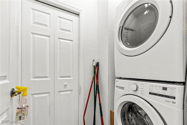 laundry room with stacked washing maching and dryer