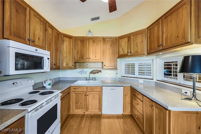 kitchen with lofted ceiling, sink, ceiling fan, light hardwood / wood-style floors, and white appliances