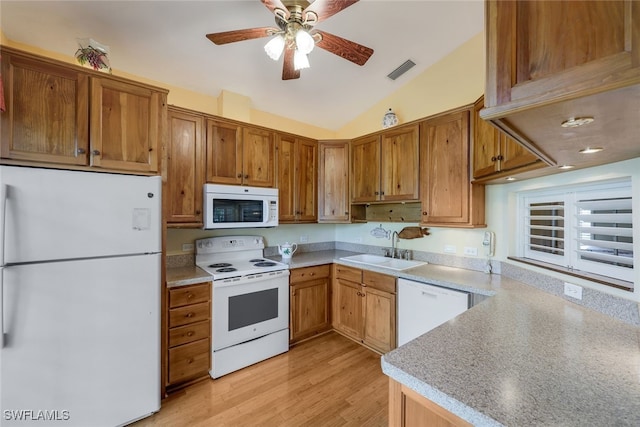 kitchen featuring lofted ceiling, sink, white appliances, light wood-type flooring, and ceiling fan