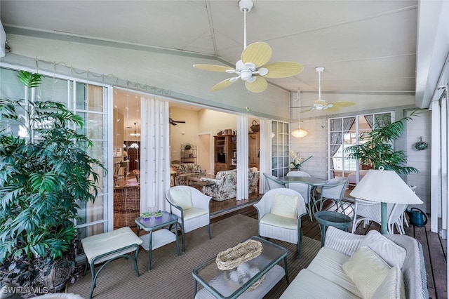 sunroom featuring ceiling fan and vaulted ceiling