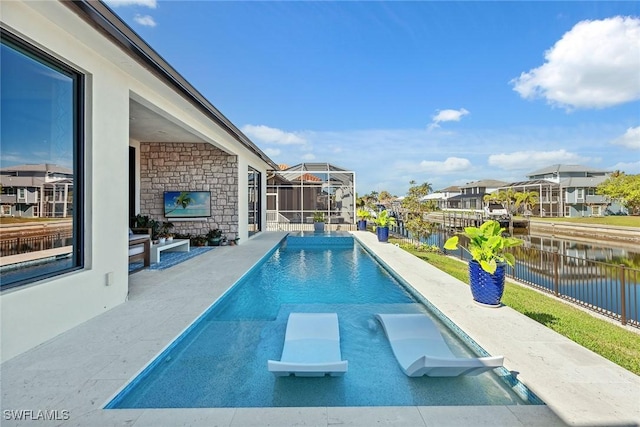 view of swimming pool with a water view, a lanai, a diving board, and a patio area