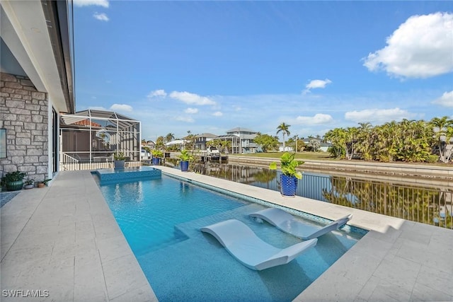 view of pool with a patio, a water view, and glass enclosure