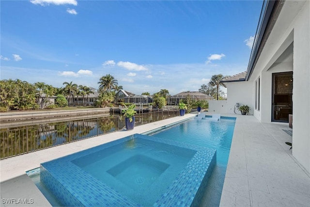 view of swimming pool with an in ground hot tub and a water view