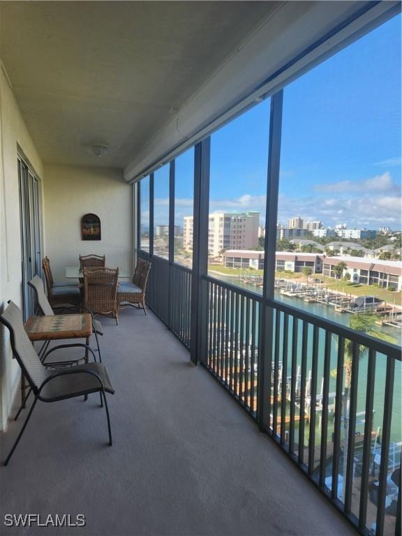 sunroom / solarium featuring a water view